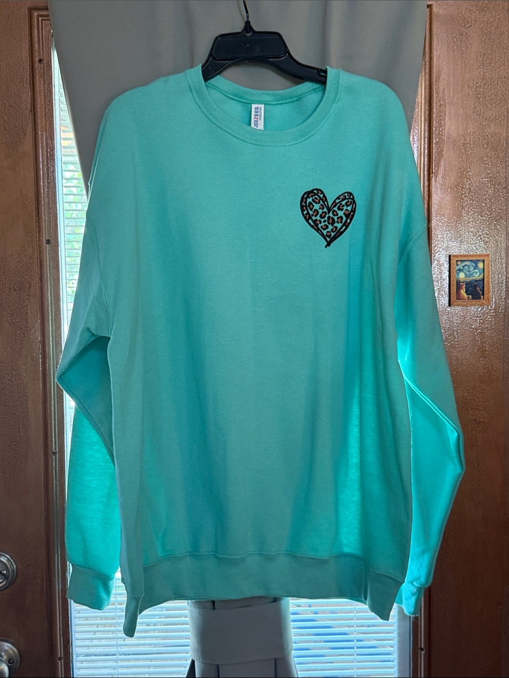 Light green sweatshirt with embroidery appliqué size xl.
